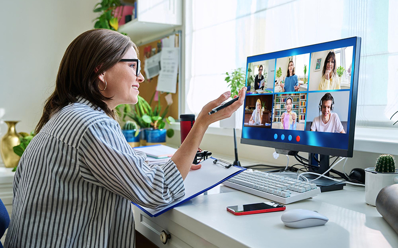 Teacher hosting a virtual class via multimedia video conferencing.